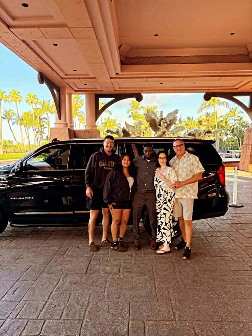 Mike with a family under the Atlantis porte-cochère
