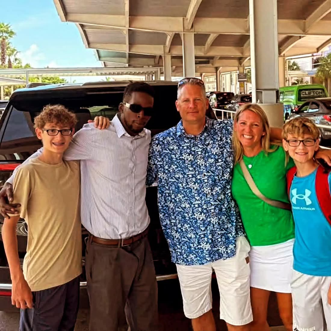 Mike with a family at the airport