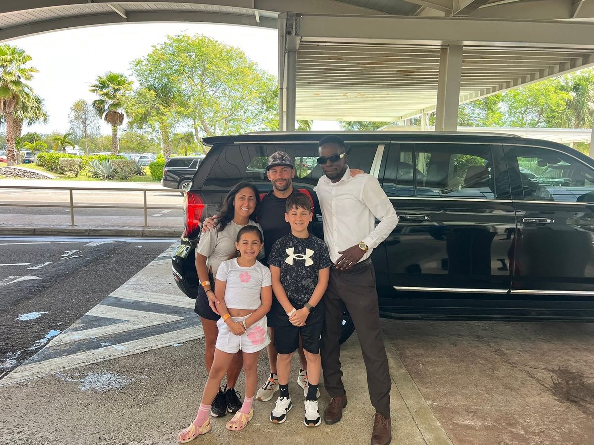Mike with a family beside the Yukon at Nassau airport