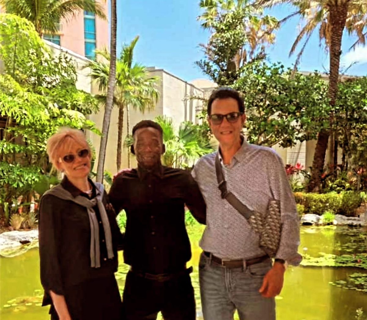 Mike with two longtime guests by a lily pond