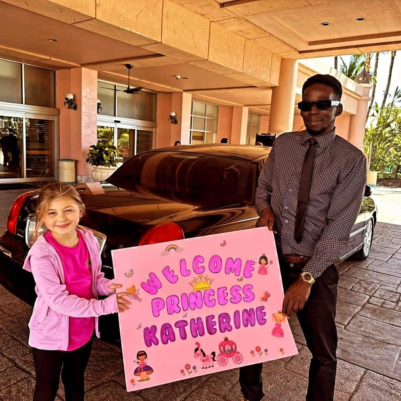 A young guest holding her Welcome Princess Katherine sign with Mike